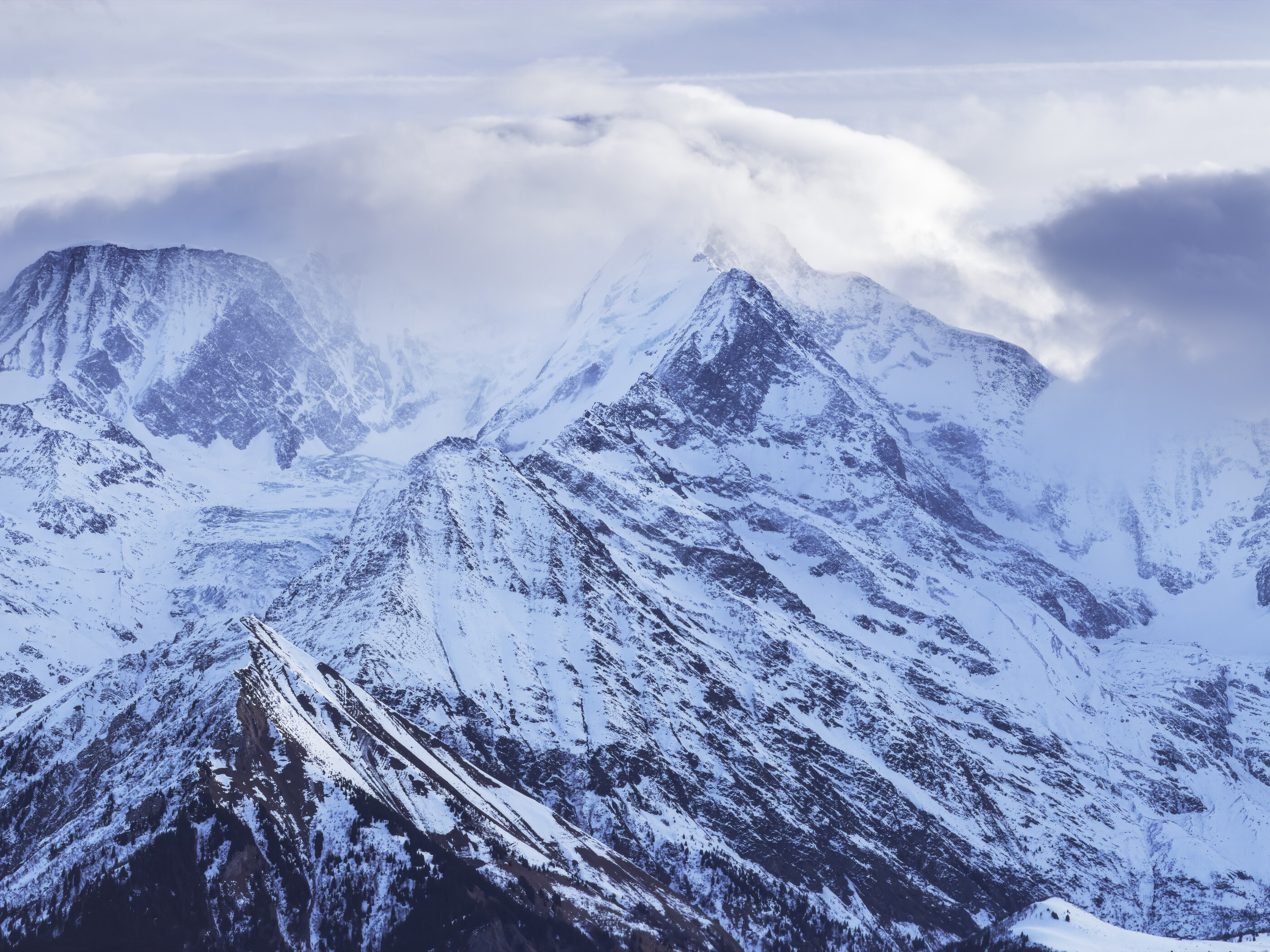 A wide snow-capped mountain range in soft afternoon light, no people, no activity. Despite the filename suggesting a portrait/award, the image is a landscape — wide place at scale.